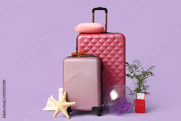 Obraz Stylish suitcases, beach accessories, passport, ticket and decor on lilac background