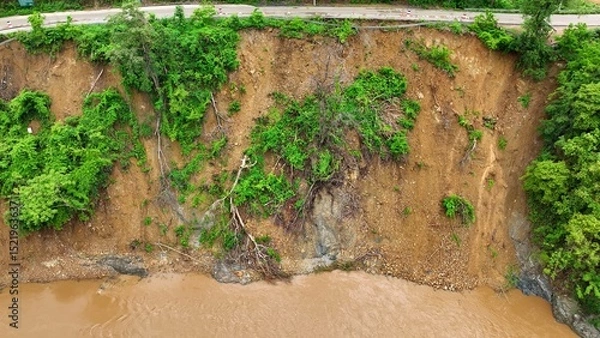 Obraz Bird’s eye perspective captures earth displacement and fallen trees from a landslide, highlighting the increased vulnerability of deforested areas to heavy rain and flooding. Thailand.
