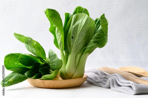 Obraz Organic Bok choy or Pak choi on wooden plate with white background, Fresh vegetable, Food ingredient