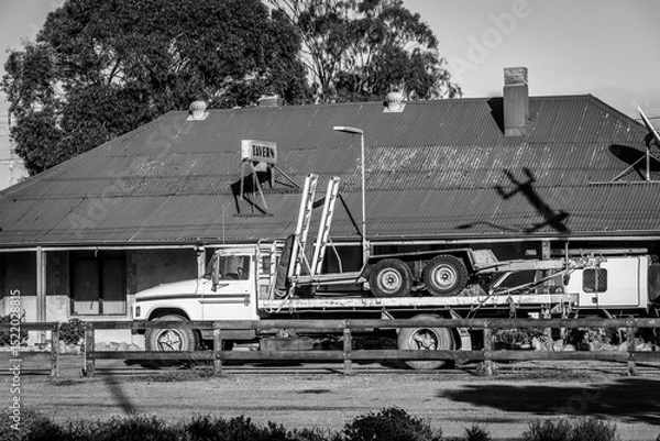 Obraz A black and white image of a truck outside an old tavern in rural Western Australia.
