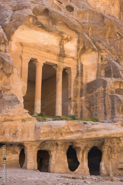 Fototapeta The ancient carved sandstone columns of Siq al Barid, Little Petra, Jordan. Buildings are formed from caves complete with cisterns for water collection. Little Petra was home to the Nabatean people.