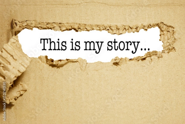 Fototapeta The words this is my story The text is hidden behind torn brown paper.