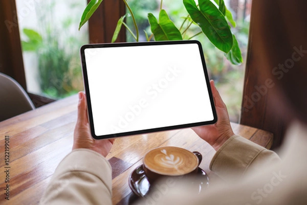 Fototapeta Mockup image of a woman holding digital tablet with blank white desktop screen
