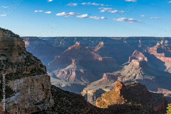 Obraz Panoramic views of the Grand Canyon, Arizona, USA, showcasing the dramatic landscape, layered rock formations, and vivid colors under a clear sky. Perfect for travel and nature themes.