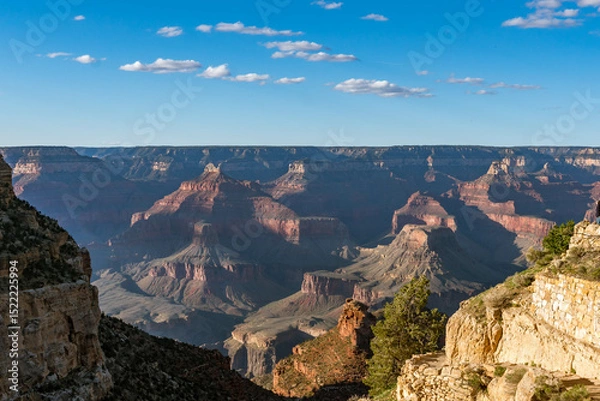 Obraz Panoramic views of the Grand Canyon, Arizona, USA, showcasing the dramatic landscape, layered rock formations, and vivid colors under a clear sky. Perfect for travel and nature themes.