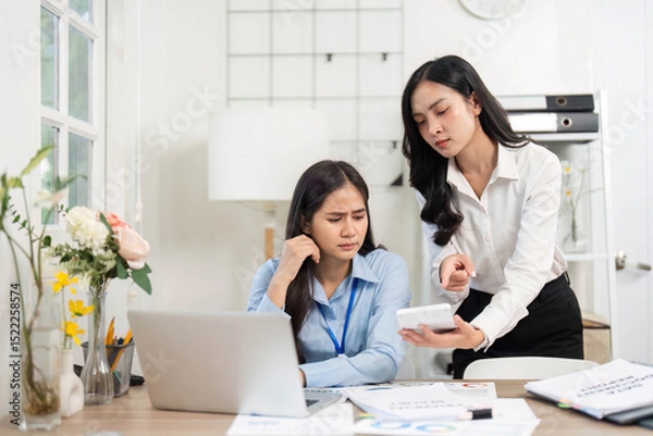 Obraz Guiding Colleague Through Challenges. Businesswoman providing direction to her stressed colleague in the office.