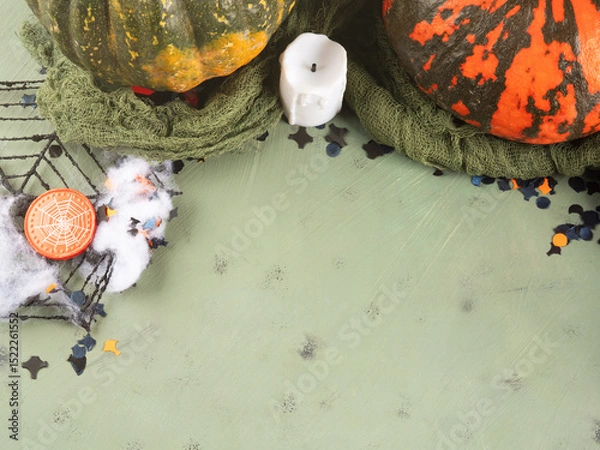 Fototapeta Halloween green frame background flatlay with colorful pumpkins and confetti