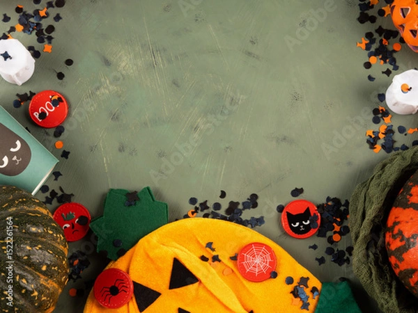 Fototapeta Halloween green frame background flatlay with pumpkins and party decor