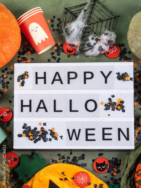 Fototapeta Happy Halloween greetings on lightbox on green with confetti