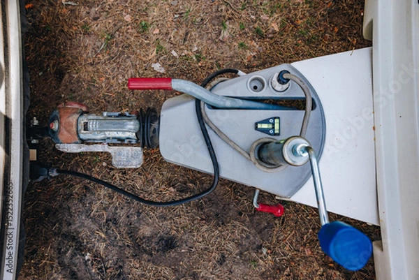 Fototapeta Hooking up caravan to a car. Сouple a trailer (i.s., hooked) into a ball-type tow hitch. Trailer coupling for caravans