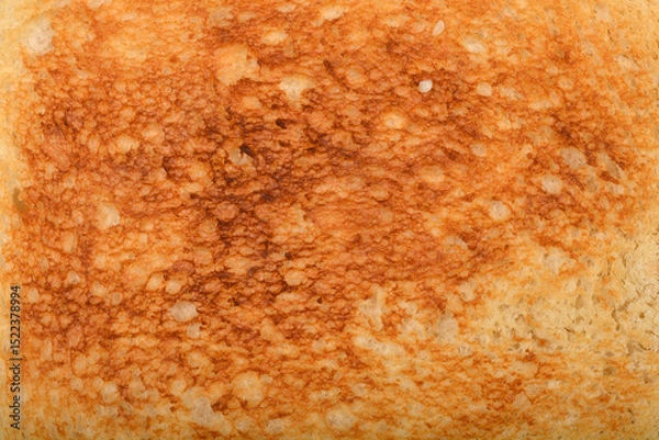 Obraz A close-up shot of a toasted white bread surface with a golden-brown texture