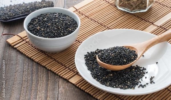Fototapeta image of sesame seeds in small plates on the table. background screen.