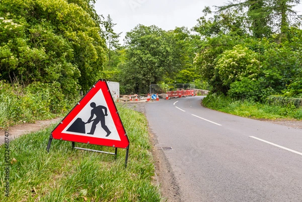 Obraz Country Road Stone Bridge Under Repair with Warning Sign Lined with Trees
