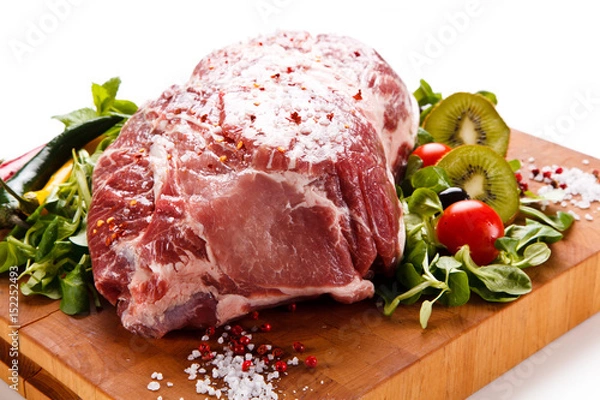 Fototapeta Fresh raw pork on cutting board on white background