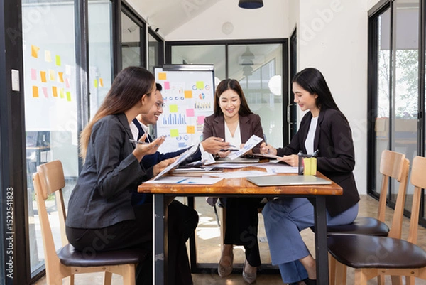 Fototapeta Group of Asian business working plan analysis project brainstorm in modern office, Asian businesspeople team working together, Business startup and company strategy planning concept.
