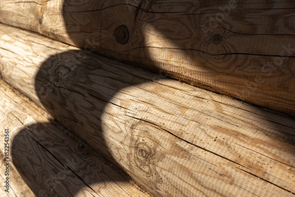 Obraz Close-up of a wooden log wall surface with sunlight