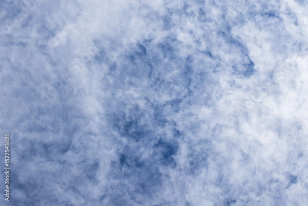 Obraz Wispy white clouds against a vibrant blue sky create a serene mood