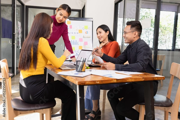 Fototapeta Group of Asian business working analysis project brainstorm in modern office, Asian businesspeople team working together, Business startup and company strategy planning concept.