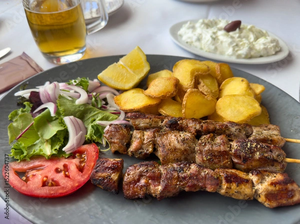 Obraz souvlaki skewers with tzatziki and garlic potatoes and tomato