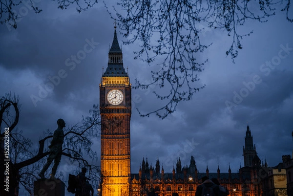 Fototapeta Illuminated Big Ben at Dusk with Silhouetted Trees