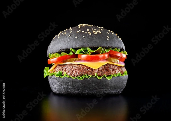 Obraz Black burger isolated on black background. 