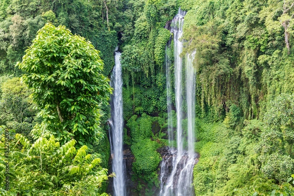 Obraz Triple waterfall at Sekumpul waterfall, northern Bali, Indonesia. Water cascading down steep cliffs, covered in lush jungle vegetation.
