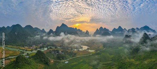 Obraz amazing aerial view of colorful sky at sunrise over mountains. The serene landscape, dotted with valleys and rivers, creates a mesmerizing contrast against the glowing clouds. wonderful landscape