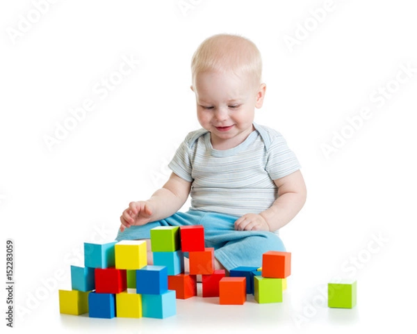Fototapeta Kid building from toy blocks. Isolated on white background