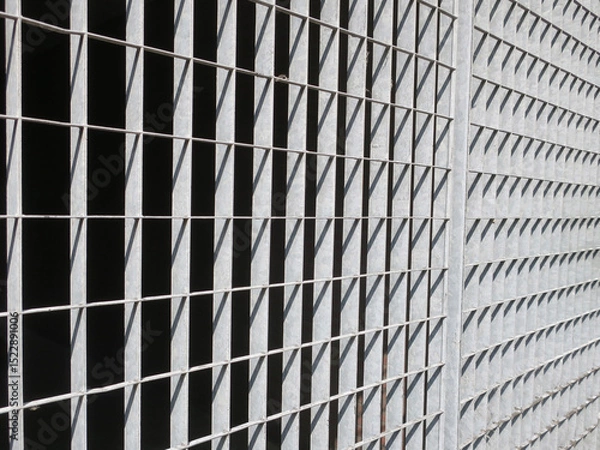 Fototapeta iron gate with rectangle shapes of shadow