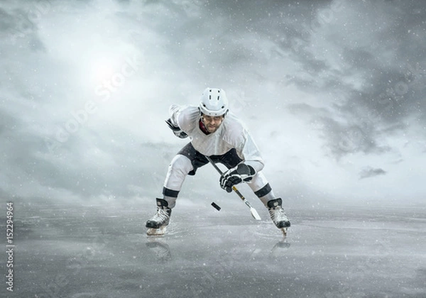 Fototapeta Ice hockey player on the ice, outdoors