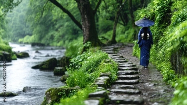 Obraz A serene path through a lush, misty forest, a person in traditional attire walks