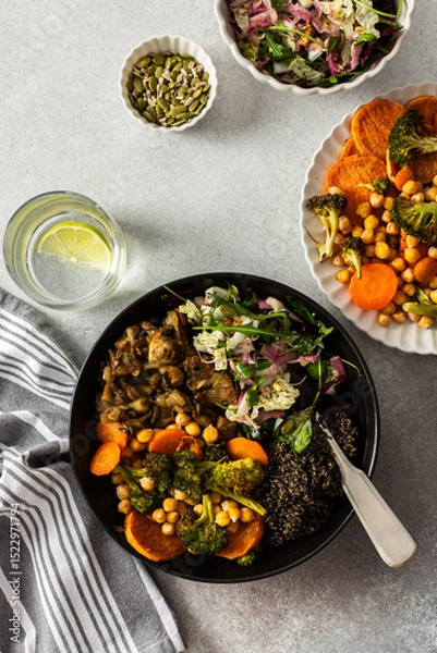 Fototapeta A balanced breakfast bowl with black quinoa, avocado, roast chicken, and sweet potatoes, topped with a fresh cabbage and radish salad