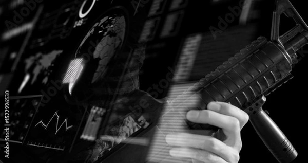 Obraz Image of hand of soldier holding gun over globe and data on digital interface, black and white