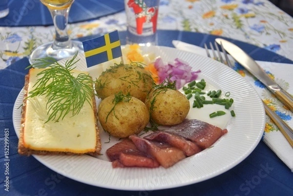 Obraz Traditional Swedish food for midsummer. New potatoes with dill, pickled herring with onions and sour cream.