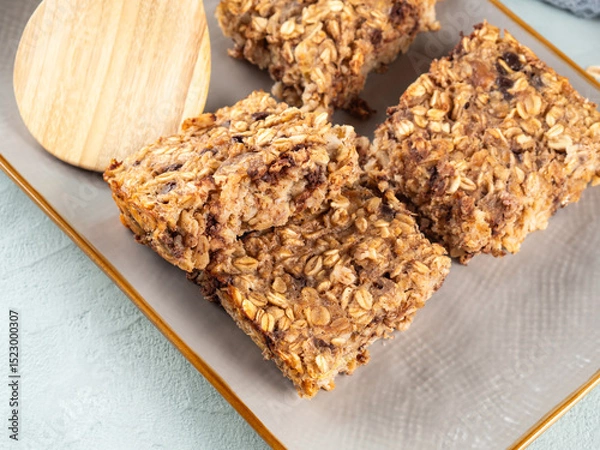Fototapeta Baked oatmeal peanut butter banana cake bars with chocolate chips