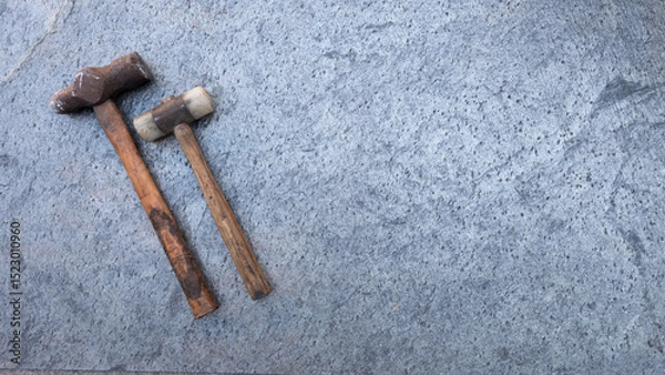 Obraz Metal and rubber hammer lying on grey textured stone surface, leaving ample copy space for text or design elements. Copy space