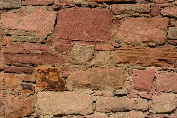 Fototapeta medieval wall made of irregular red stones