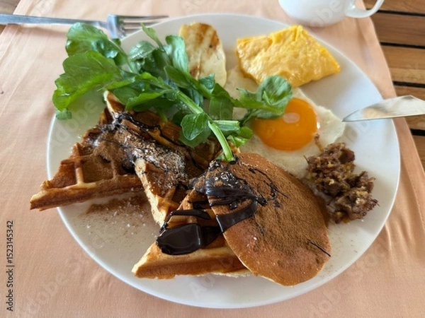Fototapeta Pancake and waffle breakfast plate with egg and greens