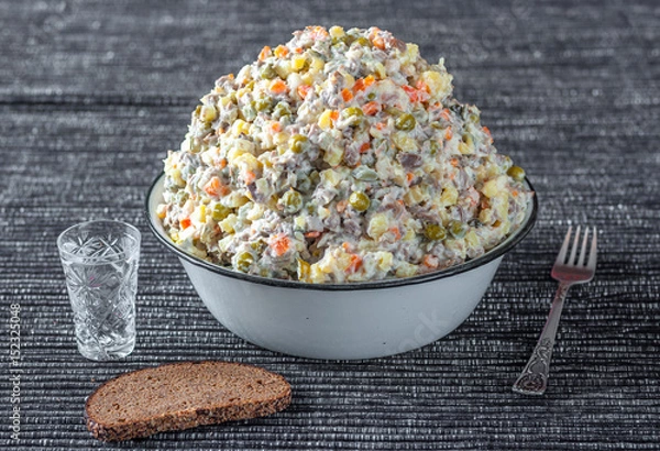 Obraz Russian traditional salad olivier with vodka and black bread, New Year. Moscow, Russia