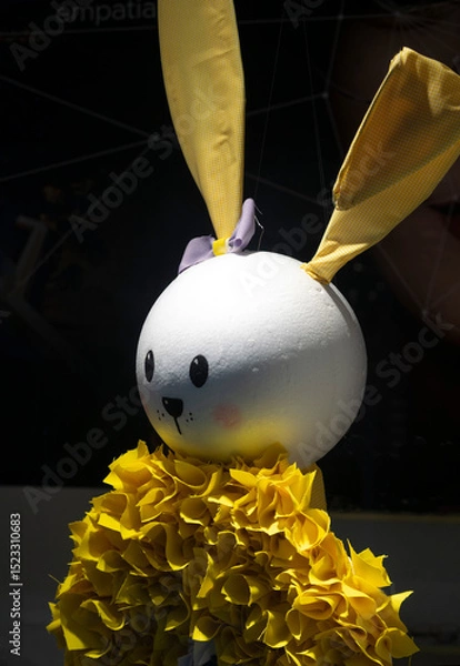 Obraz Easter handmade bunny in yellow against a black background.