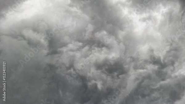 Fototapeta An intense shot of dark, swirling storm clouds filling the sky, evoking feelings of tension, turbulence, and the power of nature.