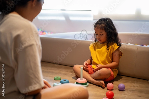 Obraz Preschool kids playing with toy at home. Wooden rainbow, eco-friendly playthings. Children organized storage promote learning, fun, and sustainability in a safe space.