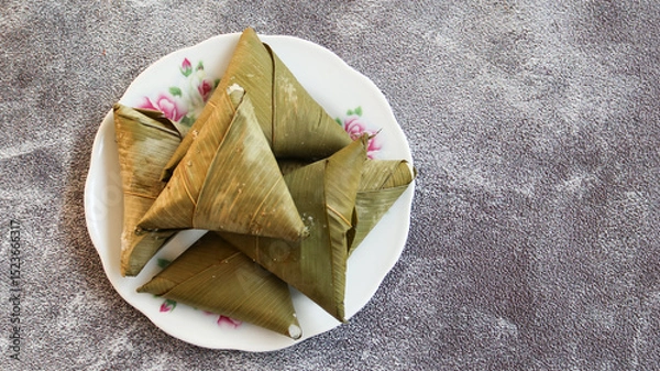 Obraz sumpil or Lontong segitiga, lontong with triangel shaped is an Indonesian dish. Rice is rolled inside a leaf and boiled, then cut into small cakes as a staple food replacement of steamed rice.top view