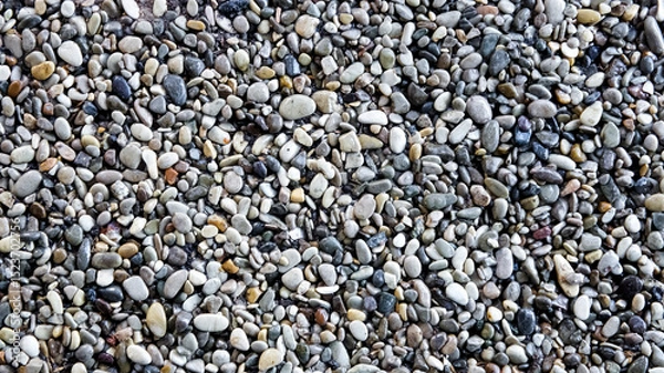 Fototapeta Smooth Azov pebble texture for landscaping or construction with mixed colors, copy space
