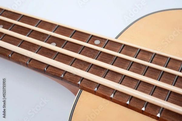 Obraz Four-string bass ukulele with wooden body and built-in tuner and pickup.