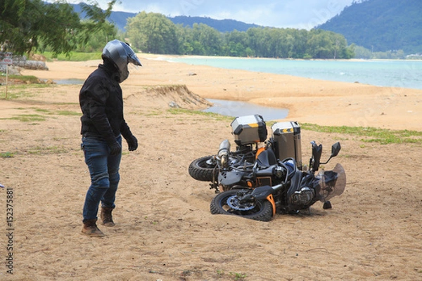 Fototapeta man got accident of motorcycle on beach