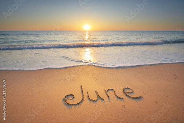 Obraz June word written on the sandy sea coast shore.