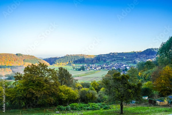 Obraz View of the landscape at the Meerfelder Maar. Nature at the crater lake in the Volcanic Eifel National Park. The surrounding area near Meerfeld at sunset in the evening.
