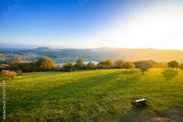 Obraz View of the landscape at the Meerfelder Maar. Nature at the crater lake in the Volcanic Eifel National Park. The surrounding area near Meerfeld at sunset in the evening.
