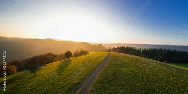 Obraz View of the landscape at the Meerfelder Maar. Nature at the crater lake in the Volcanic Eifel National Park. The surrounding area near Meerfeld at sunset in the evening.

